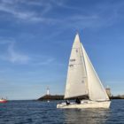 Beginner sailors enjoying a Try Sailing experience in Howth, Dublin with Howth Yacht Club instructors on a sunny day